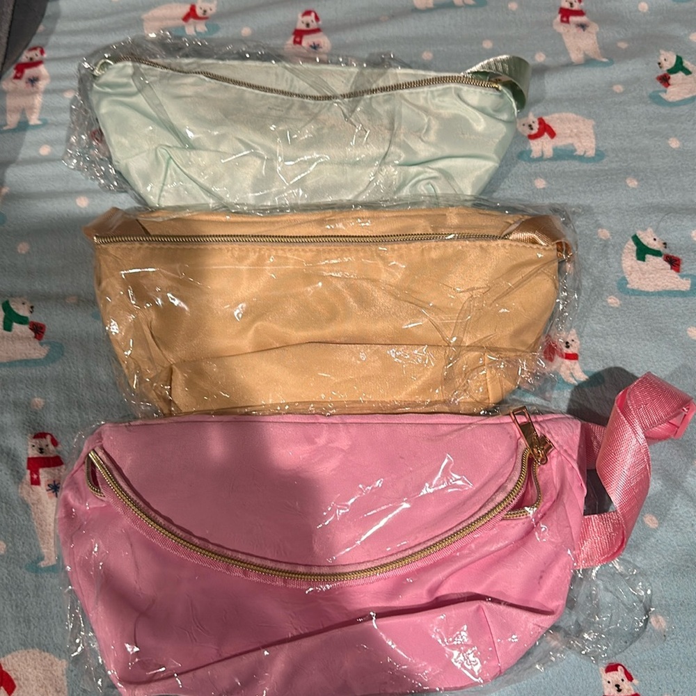 Three fanny packs never used brand new in package.